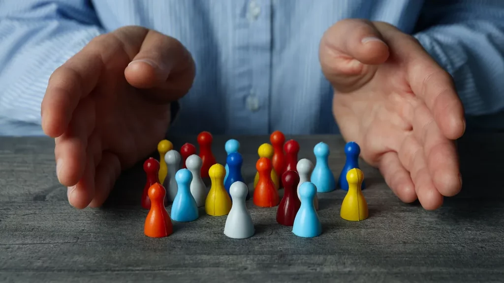 A leader guiding and protecting a diverse team, symbolizing effective leadership and organizational behaviour.